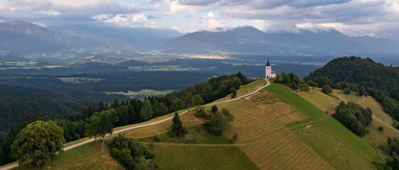 Idyllic scenery in Slovenia with an old church on a hill in Jamnik