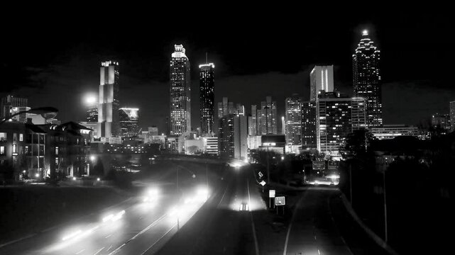 timelapse of traffic moving in and out of downtown Atlanta, black and white.
