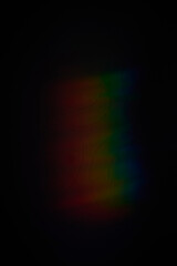 a rainbow shadow on the wall of the room