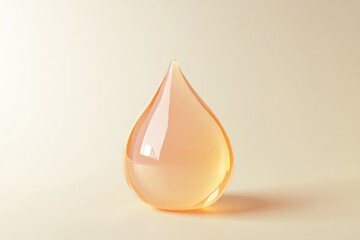 Fototapeta premium A close-up of a translucent orange liquid droplet standing on a smooth surface.