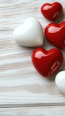 Fototapeta premium Decorative red and white hearts arranged on a wooden board provide a romantic background perfect for Valentine's Day greetings and messages