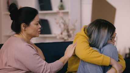 Caring mom comforts her upset teenage daughter, helping her cope with depression