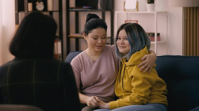 Asian teen girl and her mom feel pleased with the therapy session outcome