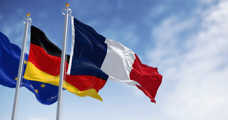Flags of France, Germany and European union waving in the wind on a clear day