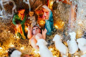 Christmas nativity scene depicting birth of jesus with mary, joseph, angel and lambs