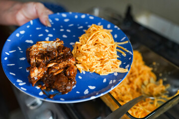 Woman serving mole poblano with spaghetti during christmas celebration in mexico