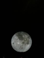 large model of the moon outside at night