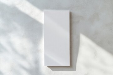 A simple white box mounted on a wall in a room, providing storage or decoration