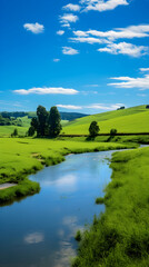 Obraz premium Spectacular Panorama of Verdant Hills Alongside a Serene River in Full Bloom Under a Blue Sky