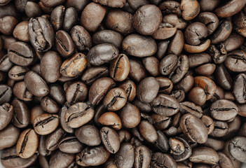 Close-up of roasted coffee beans, rich brown tones and textures. Perfect for coffee shop menus, packaging, or blog posts.
