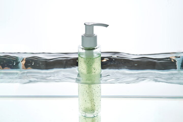 A bottle of cosmetic product in water.