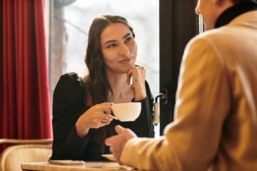 Young couple enjoys each other's company while celebrating their love at a charming restaurant.