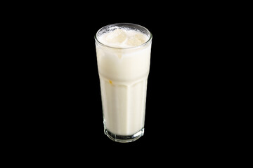 tiger nut milk with black background and ice inside of it 