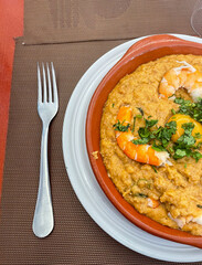 Traditional Portuguese shrimp bread stew (açorda de camarão) served in a casual snack bar setting, showcasing authentic flavors and rustic presentation.