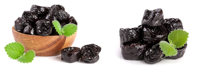 Dried plums or prunes with a mint leaf in wooden bowl isolated on white background