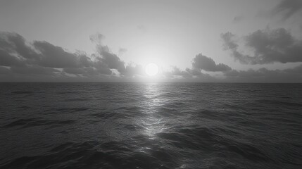 Obraz premium Monochromatic Seascape Depicting Sunlit Ocean Waves and Clouds