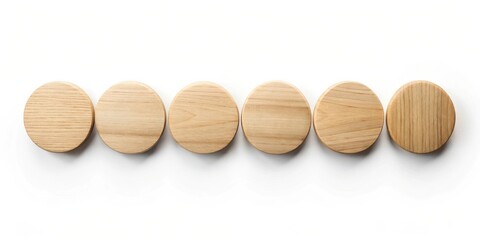 Six light brown wooden discs arranged in a row on white background