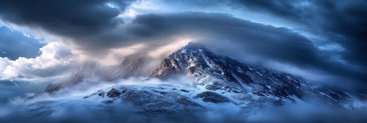 Storm clouds hovering over a snow-covered mountain peak, light rain visible