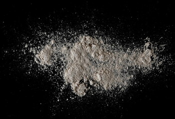 Integral spelt flour pile, isolated on black, top view