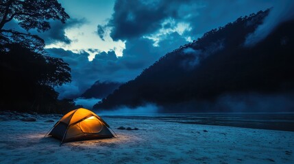 Camping by the river at night with illuminated tent surrounded by misty mountains and dramatic skies in serene natural setting