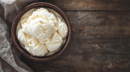 Bowl of creamy vanilla ice cream on rustic wooden surface with natural light and soft linen cloth