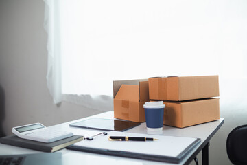 Start Up entrepreneurs who are running SME businesses are preparing products in boxes and parcels to be ready for shipping to customers. Preparing products in box and parcels to be ready for shipping.