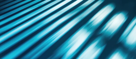 Blue window blinds casting shadows in sunlight creating an abstract background ideal for wallpapers and artistic designs.