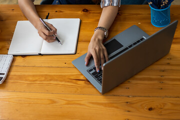 Businessman is checking the stock to meet the demand of customers who have orders and checking the correctness before shipping the goods. Checking the product orders and stock to meet the order.