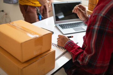 Businessman is checking the stock to meet the demand of customers who have orders and checking the...