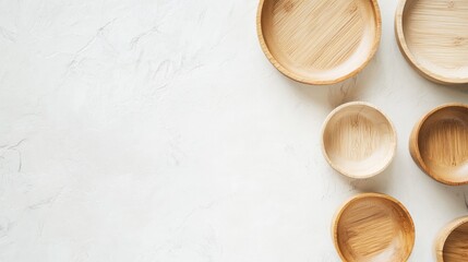 Eco-Friendly Kitchen Utensils Bamboo Plates and Bowls Displayed on Minimalist White Table Top Arrangement