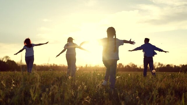 happy family running through field sunset, family child kid mother father running dream, Children Playing Field Sunset, Joyful Kid Outstretched Arms, Family Fun Nature, Carefree Childhood Moments
