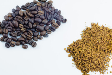 Whole coffee beans and instant coffee granules side-by-side. A comparison of two popular coffee forms.