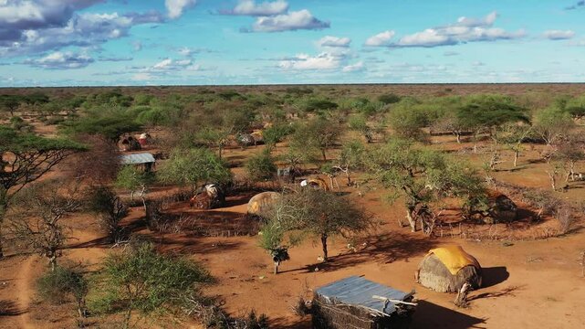  African village. Aerial view of an African village with small huts among the trees. People on the streets of Africa, everyday life. African village life. African Forests Green Vegetation View.