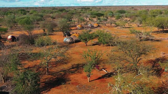  African village. Aerial view of an African village with small huts among the trees. People on the streets of Africa, everyday life. African village life. African Forests Green Vegetation View.