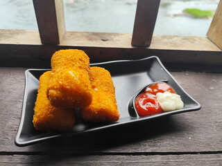 A delicious Indonesian snack called Risol and Risoles filled with chopped vegetables, smoked beef mayonnaise sauce and fried bread crumbs, served with sauce.
