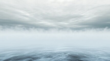 A misty ocean under a cloudy sky