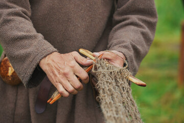 Fisherman weaving a net at a Viking festival in Denmark