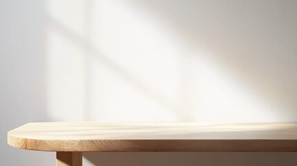 A light wooden table is set against a white background, with a beam of light shining upon it.