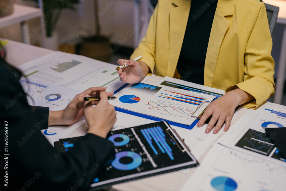 Aufkleber Two businesswomen are collaborating on a project. Analyzing financial data and business performance using charts. Graphs. And reports. Discussing strategies and making informed decisions for success