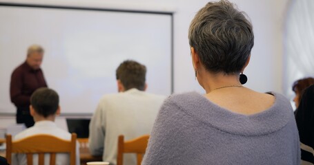 Academic lecture delivered by experienced professor, students attentively engaged, focus on higher...