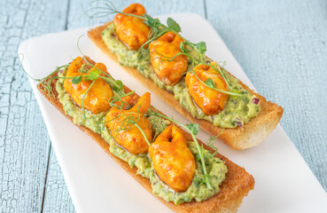 Guacamole toasts with crab claws