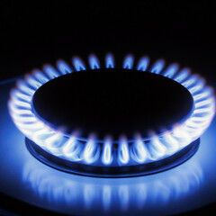 Natural Gas. High prices of natural gas. Blue flames of gas burning from a kitchen gas stove. Energy crisis concept background. Cooker with burning fire propane.