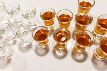 shot glasses lined up on a bar countertop ready for a celebration