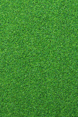 Fototapeta premium Artificial grass, covering. Artificial green grass mat, top view. Texture. Background. Artificial turf, surface made of synthetic fibers. Flat green grass texture background. Short grass