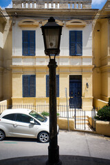 Old lamp on a colourful street on the island of Malta