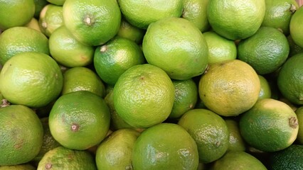 Vibrant and Fresh Green Limes Lovely Displayed in a Grocery Store for Customers to View