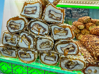 Display of Turkish delight, a popular sweet treat in Istanbul, Turkey. Arranged in a pyramid shape, with each piece cut in half to reveal layers of creamy filling and nuts. Sweetness and indulgence