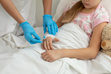 A Child Receiving Medical Care While Comfortably Resting in the Hospital Bed During Recovery