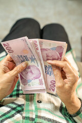 Hands holding and counting Turkish money