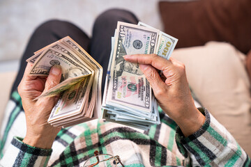 Close-up female hand counting US dollars. Financial business concept